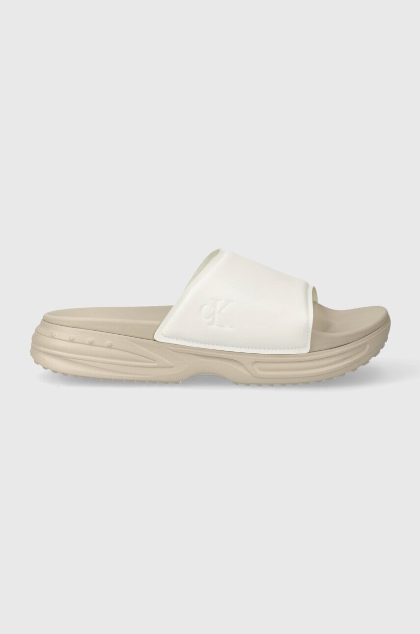 Шльопанці Calvin Klein Jeans CHUNKY COMF SLIDE MINIMAL RAW чоловічі колір бежевий YM0YM00956